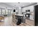 Modern kitchen with stainless steel appliances, breakfast bar, and open view to living area at 2822 Casona Way, Raleigh, NC 27616