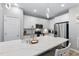 Modern kitchen with stainless steel appliances and a large island for seating at 2822 Casona Way, Raleigh, NC 27616