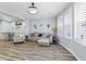 Bright living room with couch, accent chair, and large windows at 2822 Casona Way, Raleigh, NC 27616