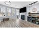 Bright living room with fireplace, bar area, and large windows for natural light at 2822 Casona Way, Raleigh, NC 27616