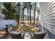 A cozy outdoor patio with wicker chairs, a grill, and a view of the backyard at 2822 Casona Way, Raleigh, NC 27616
