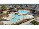 Aerial view of community pool with slides, lap lanes, and lush landscaping at 2822 Casona Way, Raleigh, NC 27616