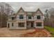 Two-story home featuring multiple windows and a modern design in the process of being built at 2916 Frances Marie Ln, Raleigh, NC 27603