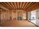 Interior view of a home under construction with a fireplace and sliding glass doors to the outside at 2916 Frances Marie Ln, Raleigh, NC 27603