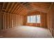 Unfinished room with vaulted ceiling, showing the wood framing and a large window for natural light at 2916 Frances Marie Ln, Raleigh, NC 27603