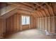 Unfinished room featuring a vaulted ceiling with a large window providing abundant natural light at 2916 Frances Marie Ln, Raleigh, NC 27603