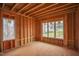 Inside a new home under construction, highlighting framed walls, subfloor, and view from bright, ample windows at 2916 Frances Marie Ln, Raleigh, NC 27603