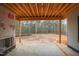 Covered patio area with exposed beams, offering an outdoor living space and backyard views at 2916 Frances Marie Ln, Raleigh, NC 27603