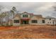 Newly constructed home showcasing the back of the property with large windows and a covered patio at 2916 Frances Marie Ln, Raleigh, NC 27603