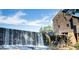 Scenic view of Yates Mill featuring a large waterfall and historic mill building at 2916 Frances Marie Ln, Raleigh, NC 27603