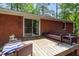 Outdoor deck with a brick wall, sliding door, and wicker furniture for outdoor living at 2968 Tram Rd, Fuquay Varina, NC 27526