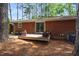 Cozy backyard with brick home, a wooden deck, and a well-maintained lawn at 2968 Tram Rd, Fuquay Varina, NC 27526
