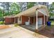 A covered brick carport with a storage area, next to the front porch of the home at 2968 Tram Rd, Fuquay Varina, NC 27526