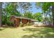 Brick home featuring mature landscaping, a driveway, and a well-manicured front lawn at 2968 Tram Rd, Fuquay Varina, NC 27526