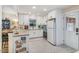 Modern kitchen with white subway tile backsplash, white appliances, and herringbone tile floor at 2968 Tram Rd, Fuquay Varina, NC 27526