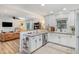 Open-concept kitchen with breakfast bar and view into the spacious living room at 2968 Tram Rd, Fuquay Varina, NC 27526