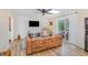 Bright living room features wood flooring, comfortable seating, and sliding glass doors to the exterior at 2968 Tram Rd, Fuquay Varina, NC 27526