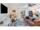 Cozy living room with shiplap wall, skylight, leather sofa, and sliding glass doors to patio at 2968 Tram Rd, Fuquay Varina, NC 27526