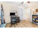 Spacious home office with ceiling fan, custom shelving, and ample natural light at 2968 Tram Rd, Fuquay Varina, NC 27526