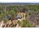 Aerial view of home situated among mature trees, showing the expansive property and surrounding landscape at 298 Bonterra Way, Chapel Hill, NC 27516