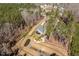 Aerial view of new construction home and property with a long driveway and a private pond at 298 Bonterra Way, Chapel Hill, NC 27516