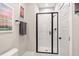 Modern bathroom with stylish tiled shower, black hardware, and a neutral patterned towel at 298 Bonterra Way, Chapel Hill, NC 27516