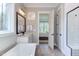 Bathroom view including a tub and showing the connecting door to the bedroom at 298 Bonterra Way, Chapel Hill, NC 27516