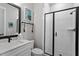 A bathroom featuring a glass shower enclosure, white cabinets and neutral walls at 298 Bonterra Way, Chapel Hill, NC 27516