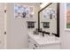 Modern bathroom vanity with decorative mirrors, patterned towels, and striped accessories on the countertop at 298 Bonterra Way, Chapel Hill, NC 27516