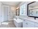 Bathroom featuring double vanity sinks, tile floors, a shower and tub at 298 Bonterra Way, Chapel Hill, NC 27516