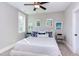 Charming bedroom featuring a ceiling fan, natural light, and a comfortable king size bed with decorative pillows at 298 Bonterra Way, Chapel Hill, NC 27516