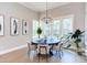 Elegant dining room with modern chandelier, bright windows, and stylish decor at 298 Bonterra Way, Chapel Hill, NC 27516