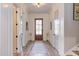 Bright foyer featuring hardwood floors, a decorative rug, and staircase access at 298 Bonterra Way, Chapel Hill, NC 27516