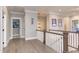 Spacious hallway with light hardwood floors and elegant trim work showcases the home's craftsmanship at 298 Bonterra Way, Chapel Hill, NC 27516
