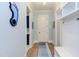 Inviting hallway featuring blue walls, hardwood floors, and a custom storage bench for organization at 298 Bonterra Way, Chapel Hill, NC 27516