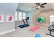 Bright home gym featuring a treadmill, weight bench, natural light, and ceiling fan at 298 Bonterra Way, Chapel Hill, NC 27516