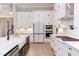 Bright kitchen with white cabinets, stainless appliances, and a contrasting island at 298 Bonterra Way, Chapel Hill, NC 27516