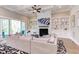 Cozy living room with coffered ceilings, fireplace, custom built-ins, and access to the deck at 298 Bonterra Way, Chapel Hill, NC 27516