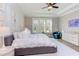 This main bedroom features a ceiling fan, large windows, and hardwood floors at 298 Bonterra Way, Chapel Hill, NC 27516