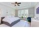 Bright main bedroom features a tray ceiling, accent wall, and large windows at 298 Bonterra Way, Chapel Hill, NC 27516