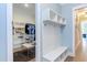 Bright mudroom features built-in storage bench, coat hooks, and open shelving next to a large walk-in closet at 298 Bonterra Way, Chapel Hill, NC 27516