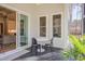 Covered outdoor patio with table and chairs, sliding door, and backyard view at 298 Bonterra Way, Chapel Hill, NC 27516