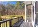 A covered outdoor porch showcases distant views of the lush backyard and the surrounding trees at 298 Bonterra Way, Chapel Hill, NC 27516