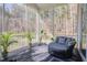 Relaxing screened porch featuring a cozy round lounge chair and peaceful wooded views at 298 Bonterra Way, Chapel Hill, NC 27516