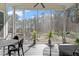 Inviting screened-in porch with a ceiling fan and outdoor seating area overlooking lush trees at 298 Bonterra Way, Chapel Hill, NC 27516