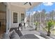 Comfortable screened-in porch featuring a ceiling fan and outdoor seating overlooking serene wooded views at 298 Bonterra Way, Chapel Hill, NC 27516
