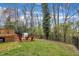 Large backyard with a deck, seating area, storage shed and trees providing a perfect space for relaxation and outdoor activities at 305 Dickens Rd, Fuquay Varina, NC 27526
