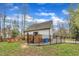 Exterior view of the backyard with a deck, outdoor seating, and fencing, creating a private outdoor living space at 305 Dickens Rd, Fuquay Varina, NC 27526