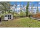 Spacious backyard with lush green grass, a storage shed, and a black metal fence, providing privacy and security at 305 Dickens Rd, Fuquay Varina, NC 27526