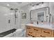 Modern bathroom featuring a tiled shower with glass door, contemporary vanity, and updated fixtures at 305 Dickens Rd, Fuquay Varina, NC 27526